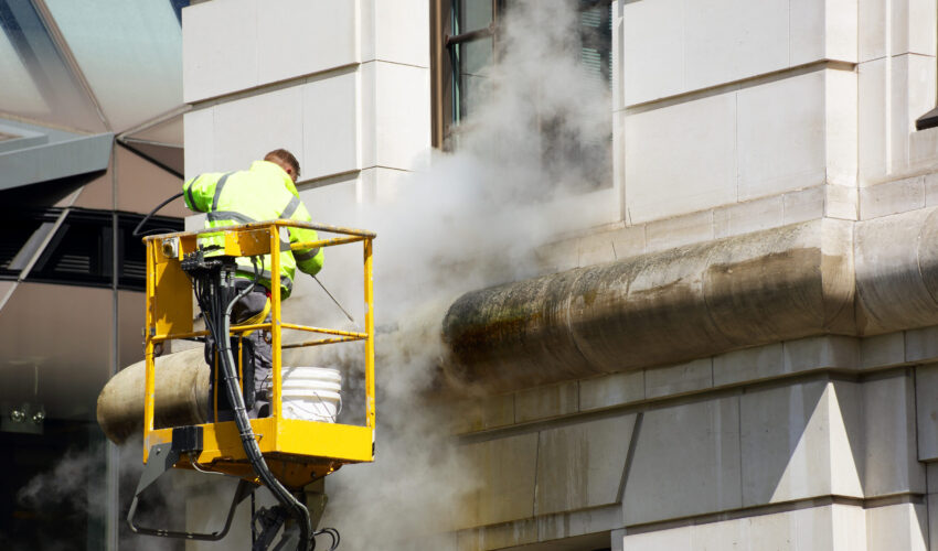 a worker washes the facade a worker washes the facade of the building